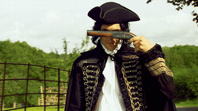 Man In Black Cape Holding Gun Over Face GIF