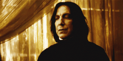 Man In Black Cape Holding Pot Before Crowd GIF