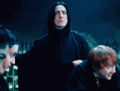 Man In Black Cape Holding Pot In Front Of Group GIF