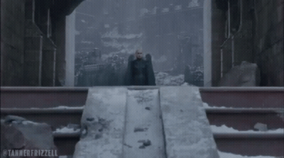 Man In Black Cape On Snowy Staircase GIF