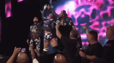 Man In Black Club Shirt Lifted By Another GIF