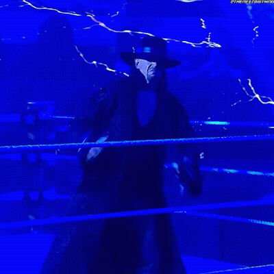 Man In Black Coat And Hat In Wrestling Ring GIF