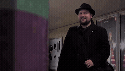 Man In Black Coat And Hat With 4 Sign GIF