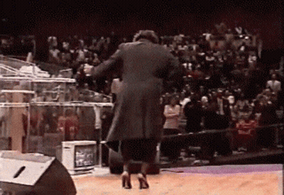 Man In Black Coat And High Heels On Stage GIF