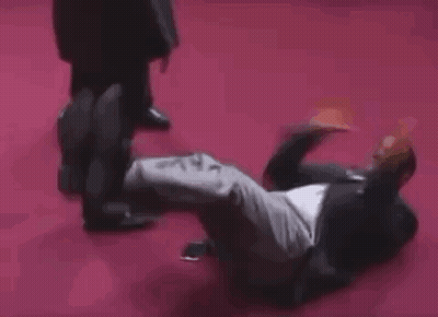 Man In Black Coat And High Heels On Stage GIF