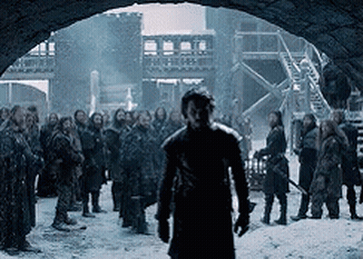 Man In Black Coat In Front Of Group GIF