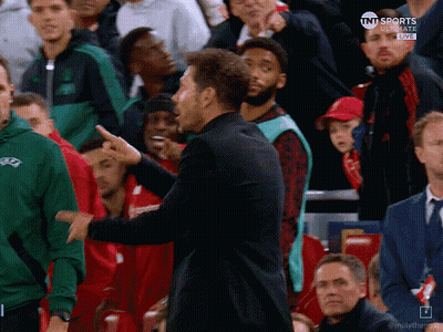 Man In Black Coat In Front Of Red Digi Seat GIF
