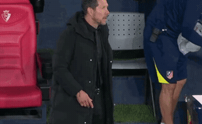 Man In Black Coat In Front Of Red Digi Seat GIF