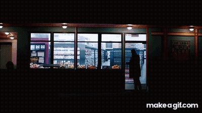 Man In Black Coat Looking At Grocery Shelves GIF