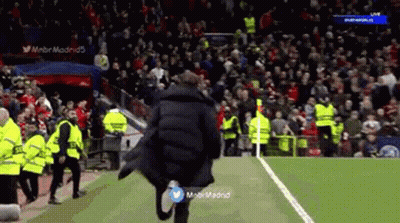 Man In Black Coat Running On Soccer Field GIF
