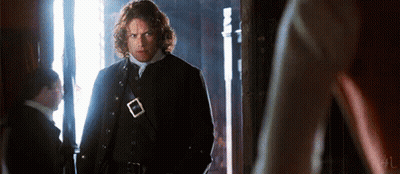 Man In Black Coat Standing In Hallway GIF