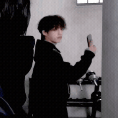 Man In Black Coat Taking Selfie GIF
