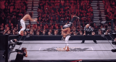 Man In Black Crew Shirt Photographing Wrestling Match GIF