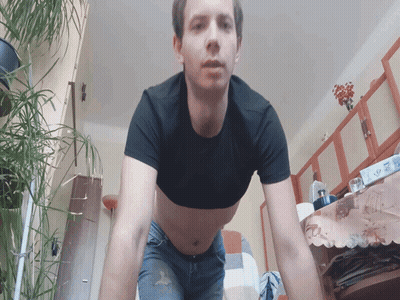 Man In Black Crop Top And Jeans Standing In Living Room GIF