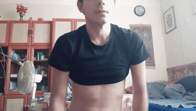 Man In Black Crop Top Standing In Room With Clock GIF