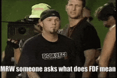 Man In Black DC Shoes Shirt In Crowd GIF