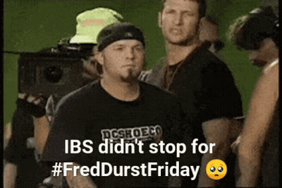 Man In Black DCSHOECO Shirt In Crowd GIF