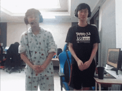 Man In Black DMM-LJ Shirt Next To Man In Pajamas GIF