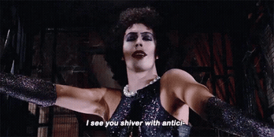 Man In Black Dress And Gloves Standing With Arms Outstretched GIF