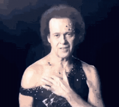Man In Black Dress Holding Chest GIF