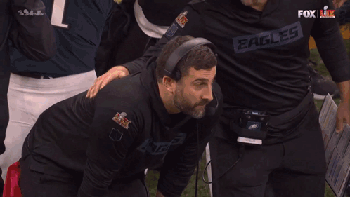 Man In Black Eagles Shirt Splashed By Fox Broadcaster GIF
