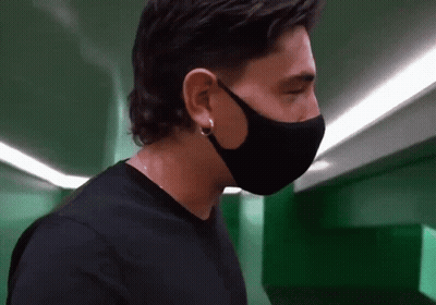 Man In Black Face Mask And Earrings Looking Down GIF