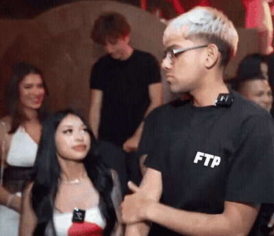 Man In Black FTP T-Shirt Talking To Woman GIF