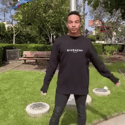 Man In Black Givenchy Sweatshirt Standing In Park GIF