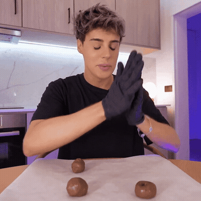 Man In Black Gloves Sitting At Table GIF