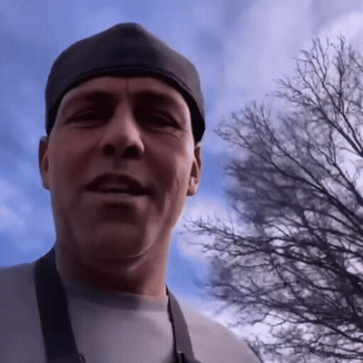 Man In Black Hat And Apron Looking At Camera GIF
