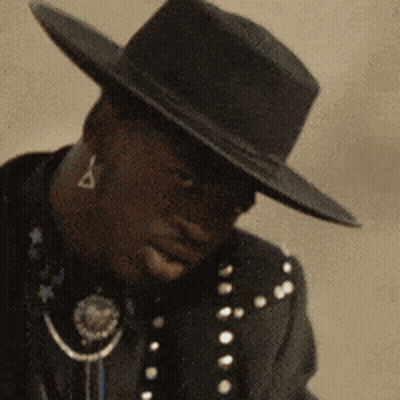 Man In Black Hat And Black Jacket With Stars Smiling GIF