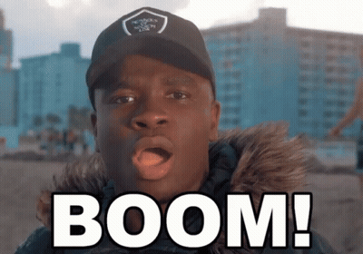 Man In Black Hat And Fur Coat Saying Boom GIF