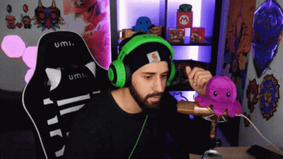 Man In Black Hat And Green Headphones Holding Octopus With Microphone GIF