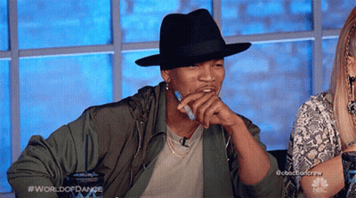 Man In Black Hat And Green Jacket At NBC Table GIF