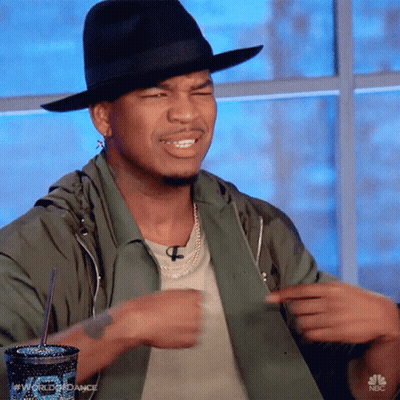 Man In Black Hat And Green Jacket Pointing GIF