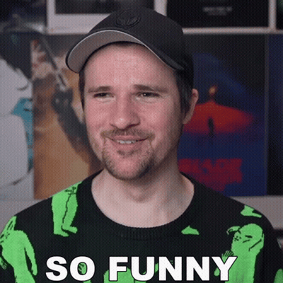 Man In Black Hat And Green Sweater Saying So Funny GIF