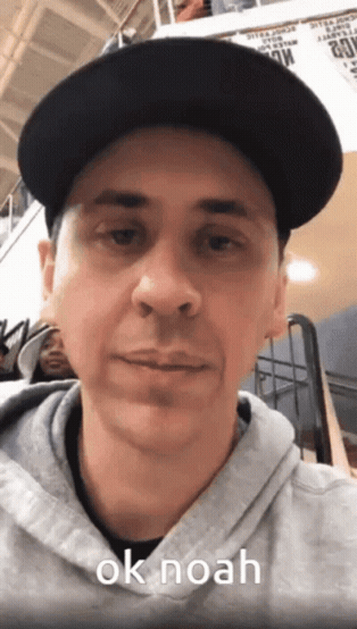 Man In Black Hat And Grey Hoodie Saying OK Noah GIF