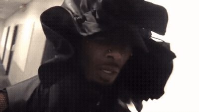 Man In Black Hat And Jacket Looking At Camera GIF