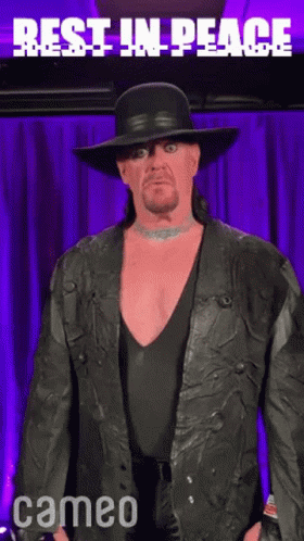 Man In Black Hat And Jacket Says Rest In Peace GIF