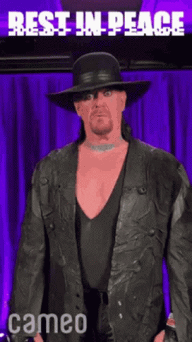 Man In Black Hat And Leather Jacket Says Rest In Peace GIF