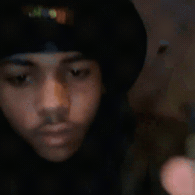 Man In Black Hat And Shirt Holding Cell Phone GIF
