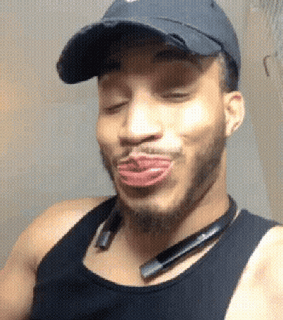 Man In Black Hat And Tank Top Making Funny Face GIF
