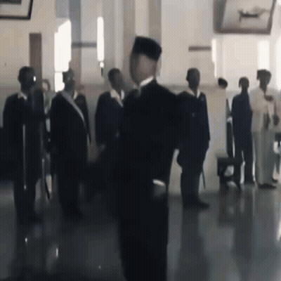 Man In Black Hat Before Group Of Men GIF