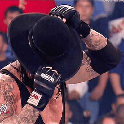 Man In Black Hat Covering Face GIF