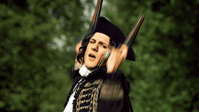 Man In Black Hat Holding Two Guns GIF