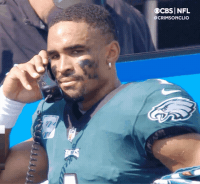 Man In Black Hat In Front Of NFL Logo GIF