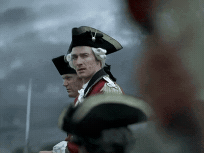 Man In Black Hat Next To Man In Red Coat GIF