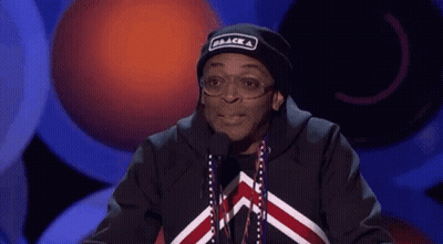 Man In Black Hat Saying Black At Microphone GIF