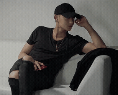 Man In Black Hat Sitting On Couch GIF