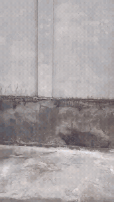 Man In Black Hat Standing By Building GIF